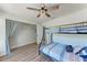 Well-lit bedroom features a bunk bed, wood-look flooring, and a ceiling fan at 6332 7Th E Ct, Bradenton, FL 34203