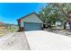 Spacious two-car garage with concrete driveway and a charming single-story home at 6332 7Th E Ct, Bradenton, FL 34203