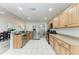 Modern kitchen with wood cabinets, stainless steel appliances and tiled floors at 6332 7Th E Ct, Bradenton, FL 34203