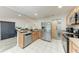 Bright kitchen featuring stainless steel appliances, granite countertops, and a stylish barn door at 6332 7Th E Ct, Bradenton, FL 34203