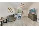 Bright living room featuring wood-look flooring, vaulted ceilings, and a cozy seating area at 6332 7Th E Ct, Bradenton, FL 34203
