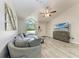 Bright living room featuring vaulted ceilings, comfortable seating and a large window at 6332 7Th E Ct, Bradenton, FL 34203