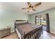 A calming main bedroom with a ceiling fan and sliding glass door to the outside patio at 6332 7Th E Ct, Bradenton, FL 34203