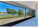 Screened porch view showcasing spacious yard with lawn at 6332 7Th E Ct, Bradenton, FL 34203