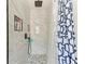 Modern shower features a pebble floor, marble-look tile surround and a rainfall shower head at 6332 7Th E Ct, Bradenton, FL 34203