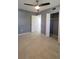 Comfortable bedroom features a ceiling fan, closet space and entrance to bathroom at 6360 Jordan St, North Port, FL 34287