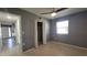 Comfortable bedroom features a ceiling fan, closet space and bright window allowing for natural light at 6360 Jordan St, North Port, FL 34287
