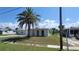 Well-maintained single-story home featuring a mature palm tree and manicured front lawn at 6360 Jordan St, North Port, FL 34287