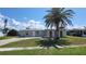 Charming single-story home with a palm tree in the front yard and a well-maintained lawn at 6360 Jordan St, North Port, FL 34287