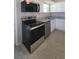 Updated kitchen featuring stainless steel appliances, neutral countertops, and modern finishes at 6360 Jordan St, North Port, FL 34287