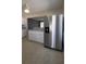 Modern kitchen with stainless steel appliances, white cabinetry, and a view into the living room at 6360 Jordan St, North Port, FL 34287