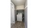 Functional laundry area equipped with a washing machine and overhead cabinet storage at 6360 Jordan St, North Port, FL 34287