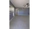 Large living room with view into the kitchen and doorway to hall with bedrooms and bathrooms at 6360 Jordan St, North Port, FL 34287