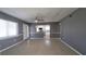 Spacious living room with modern gray paint, updated baseboards, and a ceiling fan at 6360 Jordan St, North Port, FL 34287
