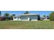 View of the back of the house and its expansive yard, including a new roof and updated windows at 6360 Jordan St, North Port, FL 34287