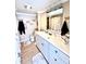 Well-lit bathroom with a white vanity, a large mirror, and modern fixtures, offers a clean and functional space at 72 4Th Ave # 72, Venice, FL 34285