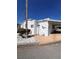 Beautiful manufactured home with bright white exterior, desert landscaping, and ample parking in a tranquil neighborhood at 72 4Th Ave # 72, Venice, FL 34285
