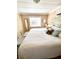 Calm main bedroom features a king-sized bed, beach-themed accents and functional storage solutions at 72 4Th Ave # 72, Venice, FL 34285