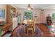 Dining area featuring wood floors, a table with chairs, a decorative hutch, and a cheerful ambiance at 7690 Castleberry Ter, Englewood, FL 34224