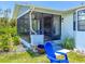 This property features a screened-in porch with a ceiling fan and outdoor seating at 7690 Castleberry Ter, Englewood, FL 34224
