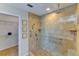 Accessible bathroom featuring tiled shower with grab bars and a walk-in closet at 8402 13Th Nw Ave, Bradenton, FL 34209