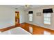 Cozy bedroom featuring hardwood floors, natural light, and an attached bathroom at 8402 13Th Nw Ave, Bradenton, FL 34209
