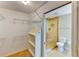 Walk-in closet leading to bathroom with tiled glass shower enclosure at 8402 13Th Nw Ave, Bradenton, FL 34209