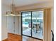 Dining area featuring a view of the screened-in pool and a glass-topped dining table at 8402 13Th Nw Ave, Bradenton, FL 34209