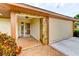 Inviting front entrance featuring a brick pathway, stone accents, and a well-maintained two-car garage at 8402 13Th Nw Ave, Bradenton, FL 34209
