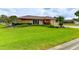 Well-maintained front yard with lush green grass, mature trees, and neatly trimmed shrubs at 8402 13Th Nw Ave, Bradenton, FL 34209