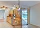 Bright kitchen with light wood cabinetry, granite countertops, and view of the pool at 8402 13Th Nw Ave, Bradenton, FL 34209
