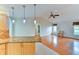 Bright living room featuring hardwood floors, a ceiling fan, and modern pendant lighting at 8402 13Th Nw Ave, Bradenton, FL 34209