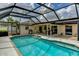 Backyard with pool inside of screened enclosure with outdoor dining and cooking space at 8402 13Th Nw Ave, Bradenton, FL 34209