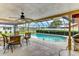 Inviting screened-in pool area with a ceiling fan and views of the backyard at 8402 13Th Nw Ave, Bradenton, FL 34209
