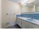 Bathroom with blue tile, marbled counter and white vanity at 8413 Lincolnshire Dr, Hudson, FL 34667