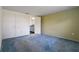 Bedroom with blue carpet, white doors and view to the bathroom at 8413 Lincolnshire Dr, Hudson, FL 34667