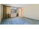 Bedroom with blue carpet and window with blinds and curtains at 8413 Lincolnshire Dr, Hudson, FL 34667