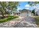 Exterior of a home with an attached garage and a long driveway in a suburban neighborhood at 8413 Lincolnshire Dr, Hudson, FL 34667
