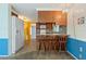 Bright kitchen features breakfast bar with seating, white appliances and wood cabinets at 8413 Lincolnshire Dr, Hudson, FL 34667