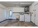 Functional laundry room with washer, dryer, utility sink, and ample storage cabinets at 8413 Lincolnshire Dr, Hudson, FL 34667