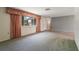 Bright living room with carpet and a large window, offering lots of natural light at 8413 Lincolnshire Dr, Hudson, FL 34667
