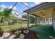 Enclosed patio with decorative rock garden and view of the backyard at 8413 Lincolnshire Dr, Hudson, FL 34667