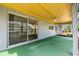 Covered patio with green carpet flooring and a ceiling fan, perfect for outdoor relaxation at 8413 Lincolnshire Dr, Hudson, FL 34667