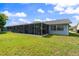 Backyard featuring a large screened-in porch, providing an excellent outdoor living area at 8413 Lincolnshire Dr, Hudson, FL 34667