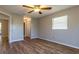 The bedroom has a window for natural light, wood floors, and a ceiling fan for added comfort at 8730 Filson Pl, Sarasota, FL 34231