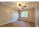 This bedroom features neutral walls, wood floors, a ceiling fan, and a window that provides natural light at 8730 Filson Pl, Sarasota, FL 34231