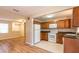 The kitchen features brown wood cabinetry, white appliances, and an open floor plan to the adjacent room at 8730 Filson Pl, Sarasota, FL 34231