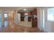 This kitchen features white appliances, brown cabinets, and wood floors extending into the adjacent room at 8730 Filson Pl, Sarasota, FL 34231