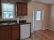 This kitchen features an undermount sink, wood cabinets and stainless dishwasher near to a backdoor at 8730 Filson Pl, Sarasota, FL 34231