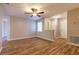 Inviting living room with wood flooring, neutral walls, a ceiling fan, and plenty of natural light at 8730 Filson Pl, Sarasota, FL 34231